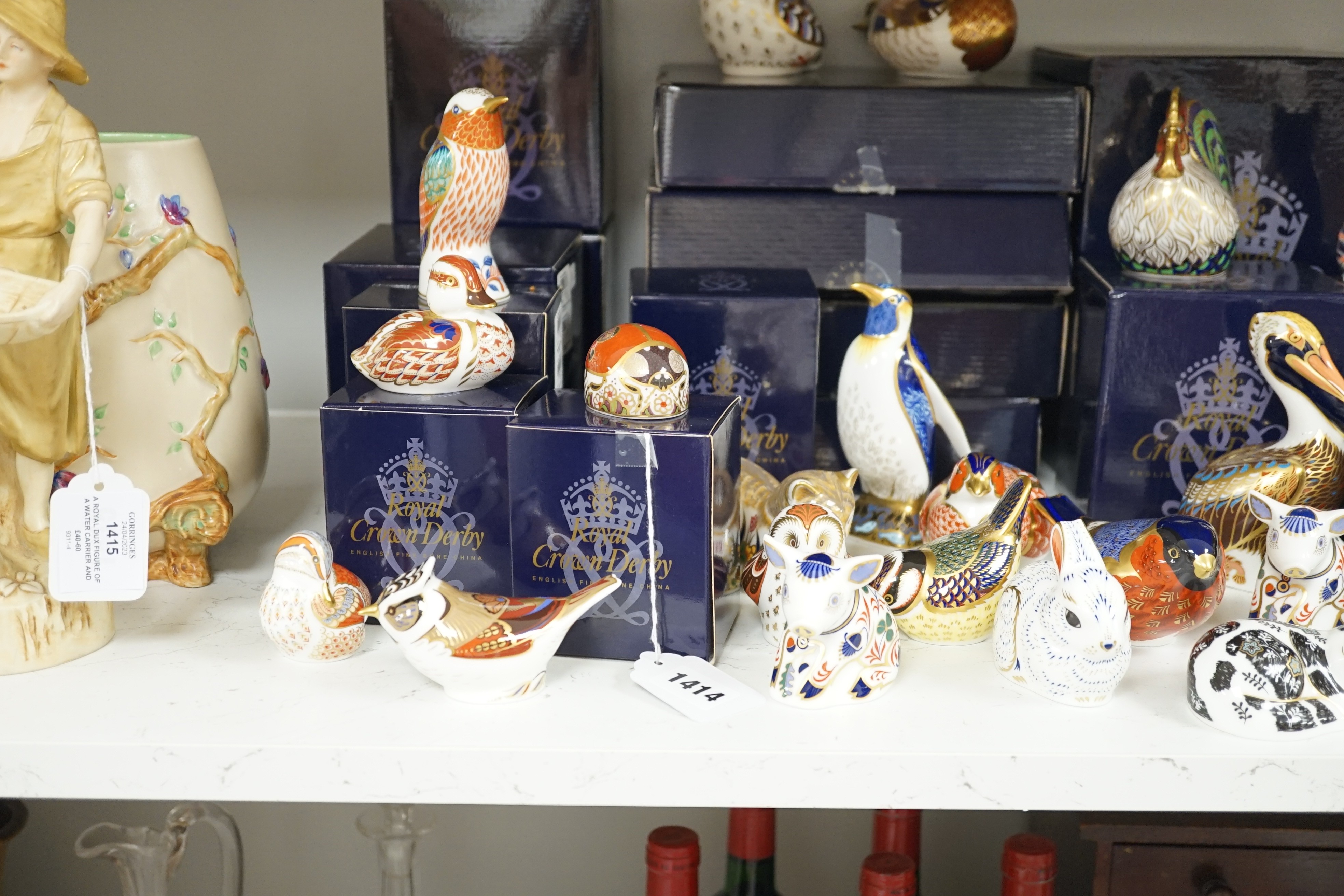 Approximately thirty-two Royal Crown Derby Imari porcelain paperweights, all but two with original boxes and mostly gold bottoms
